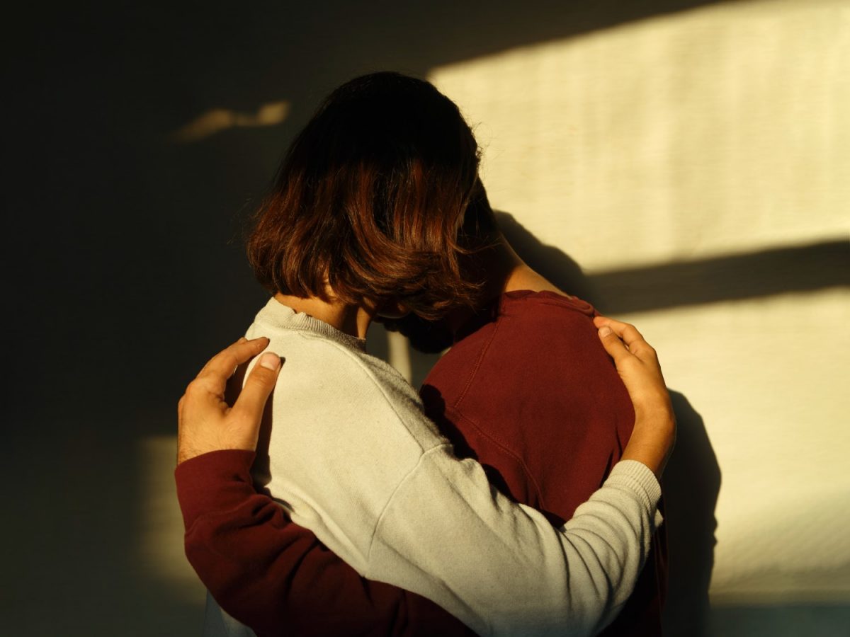 two persons hugging